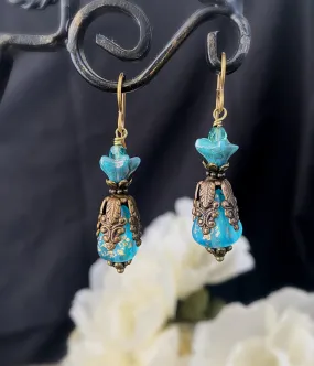 Blue Czech glass, chocolate bronze filigree flower bead caps, and bronze metal earrings.