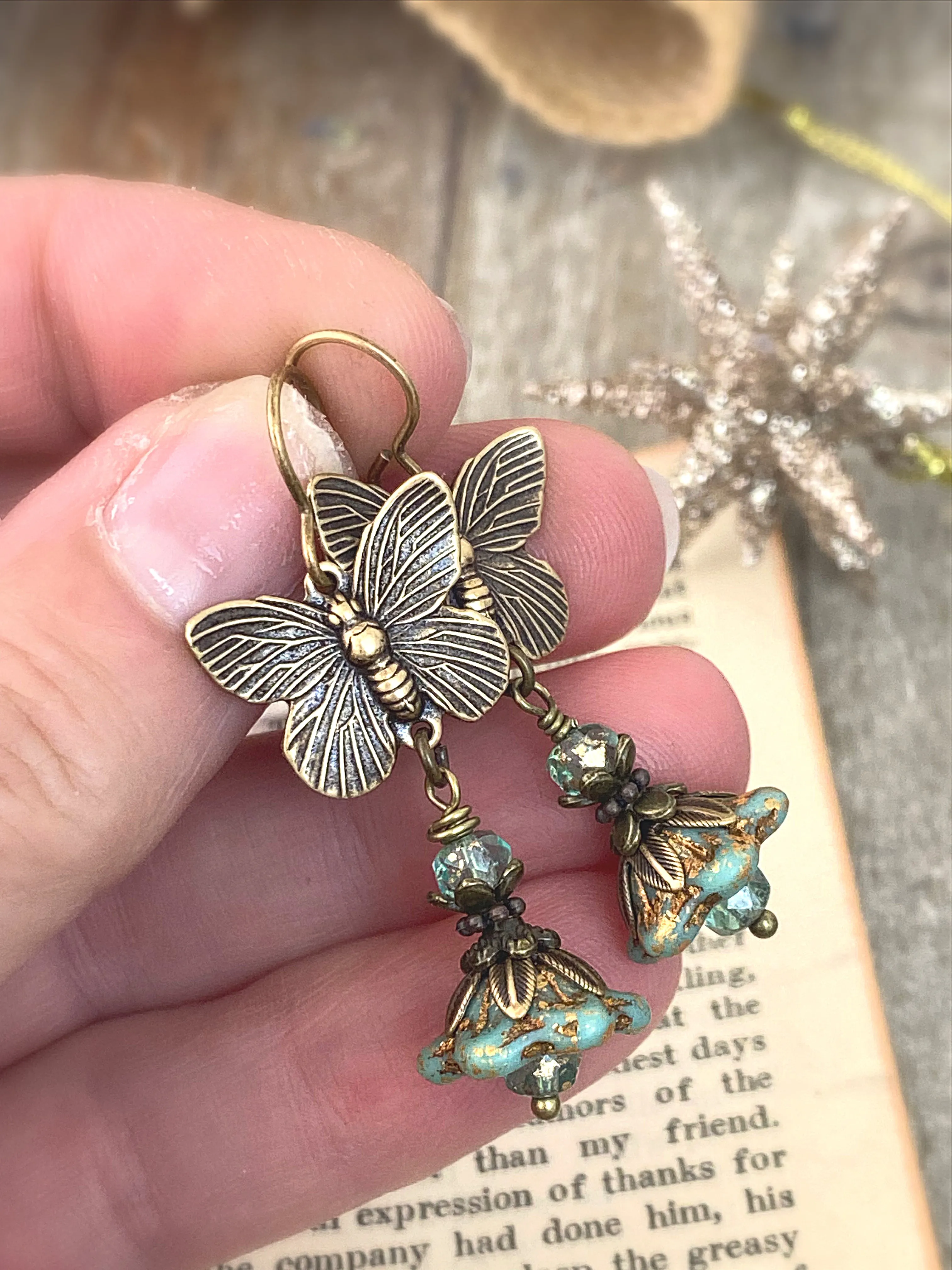 Brass butterfly charms, turquoise Czech glass, flower bead caps, bronze metal, earrings