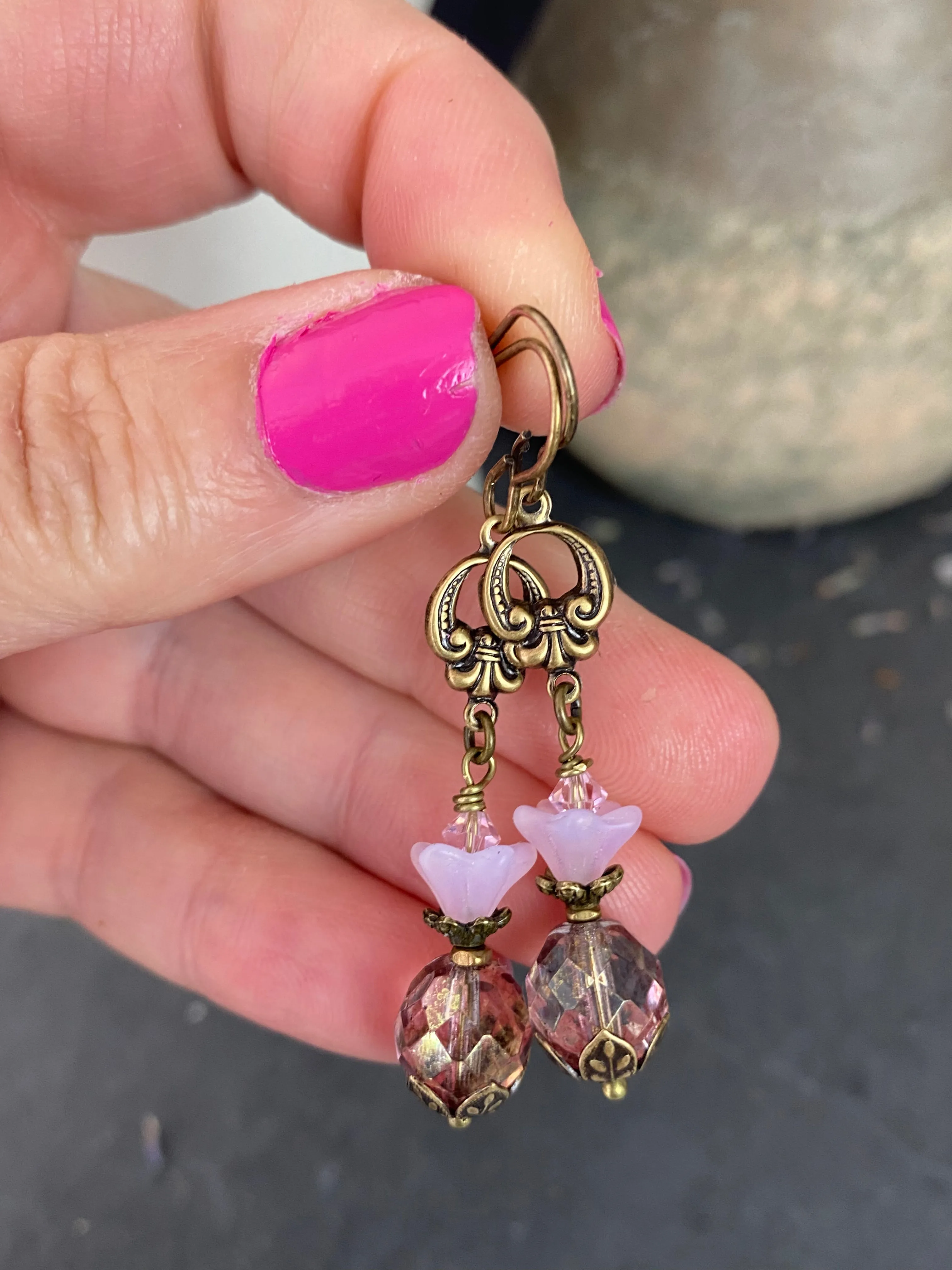 Pink Czech glass, bronze flower bead caps, and bronze metal earrings.